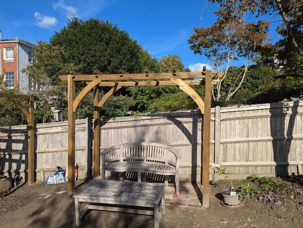 Timber pergola over a garden seating area, built by Tyrrells