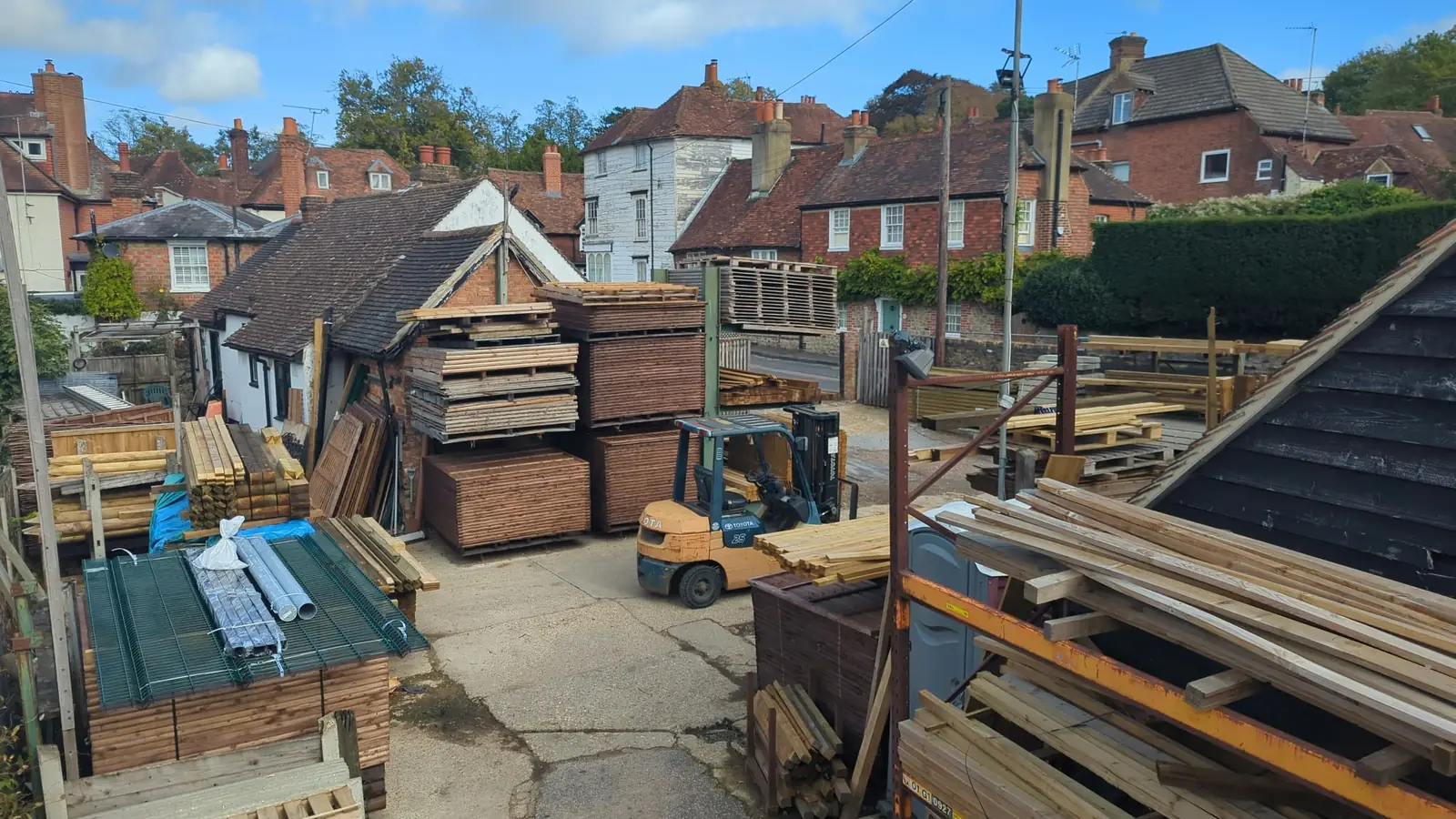 The Tyrrells timber yard in Sevenoaks, stacked with posts, rails, fence panels and mesh, with the forklift in the middle